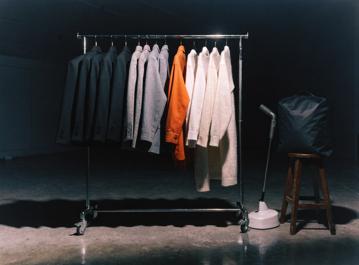 Rolling rack of jackets sorted from dark to light, staged and ready before launch